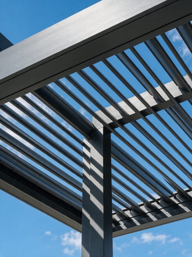 Lamas orientables de una pérgola bioclimática de aluminio vistas desde abajo contra el cielo